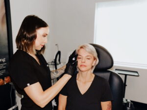 Aesthetic provider performing a Botox brow lift on a client to lift and rejuvenate tired-looking eyes.